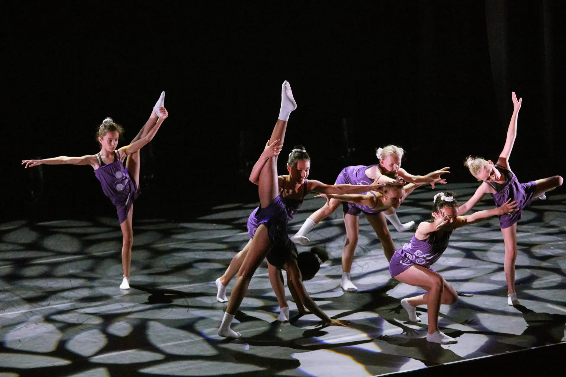 young group of dancers performing lyrical on stage