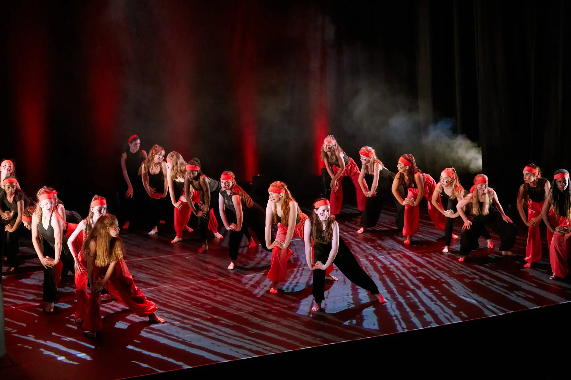 group of dancers performing a modern dance on stage