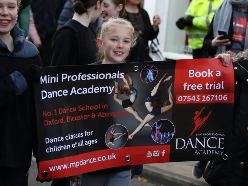 girl holding banner in abingdon Christmas performance