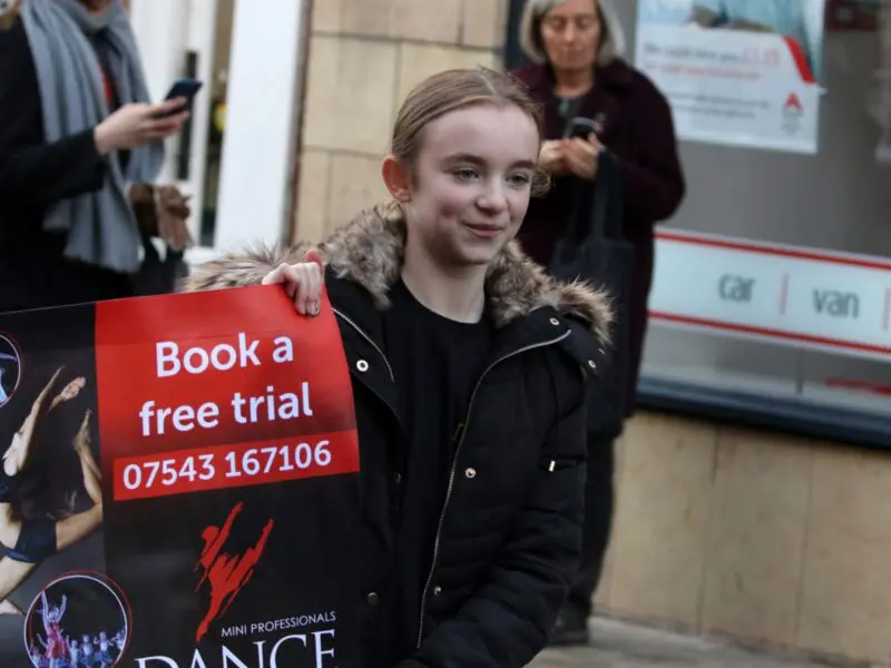 girl holding banner at abingdon Christmas performance