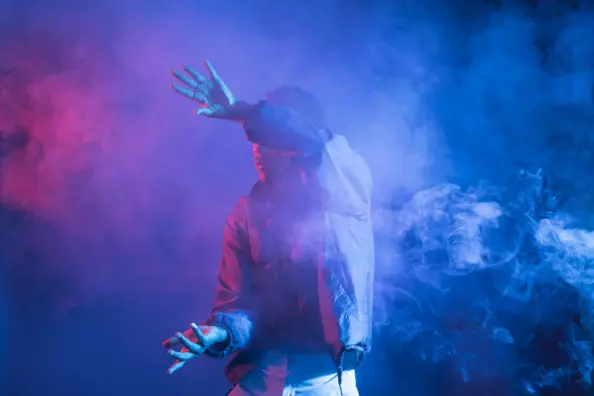 man dancing in a smoke background