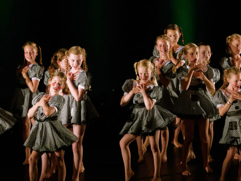 group of young dancers dressed up as dolls