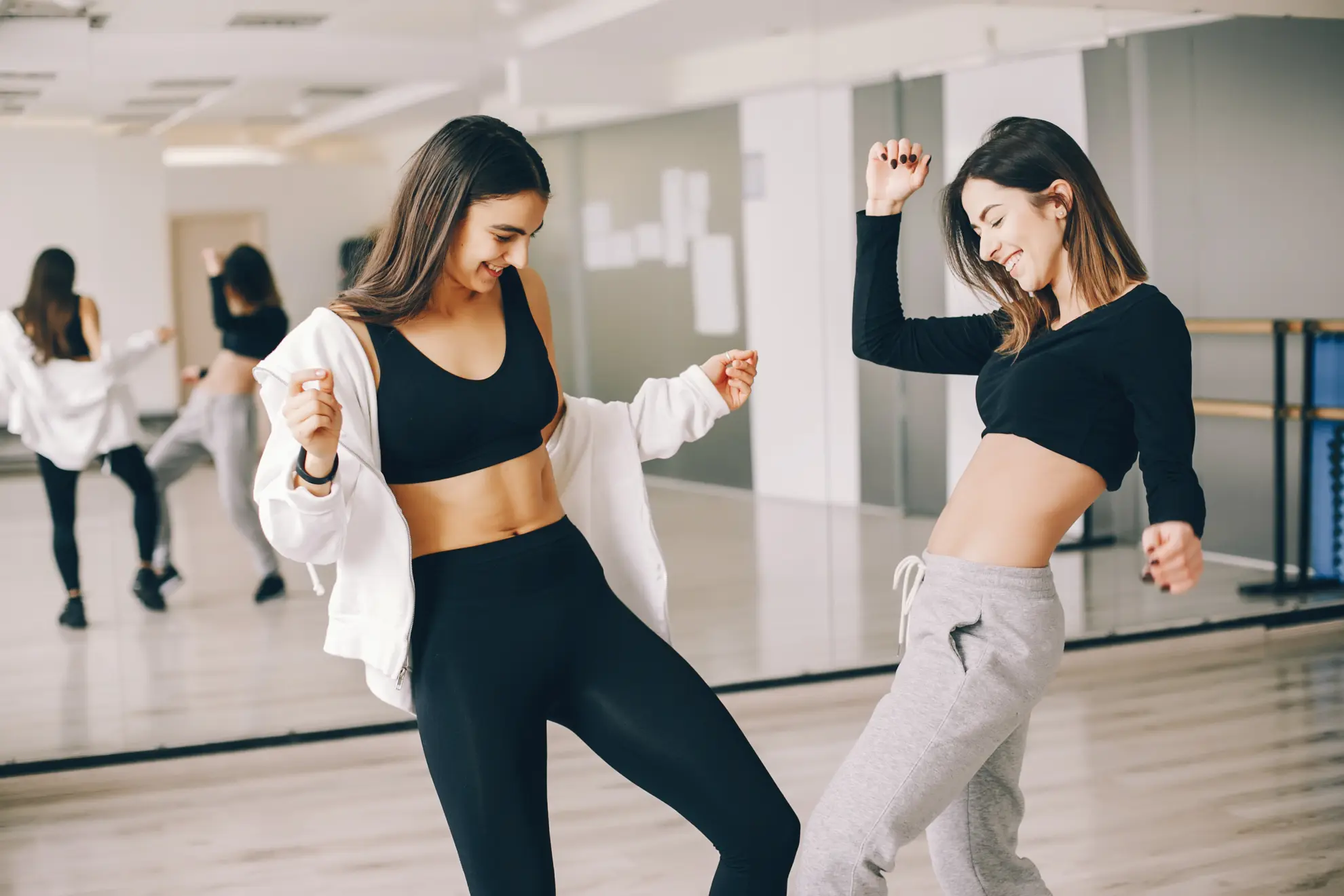 two beautiful slender girls doing dancing and gymnastics in the dance hall