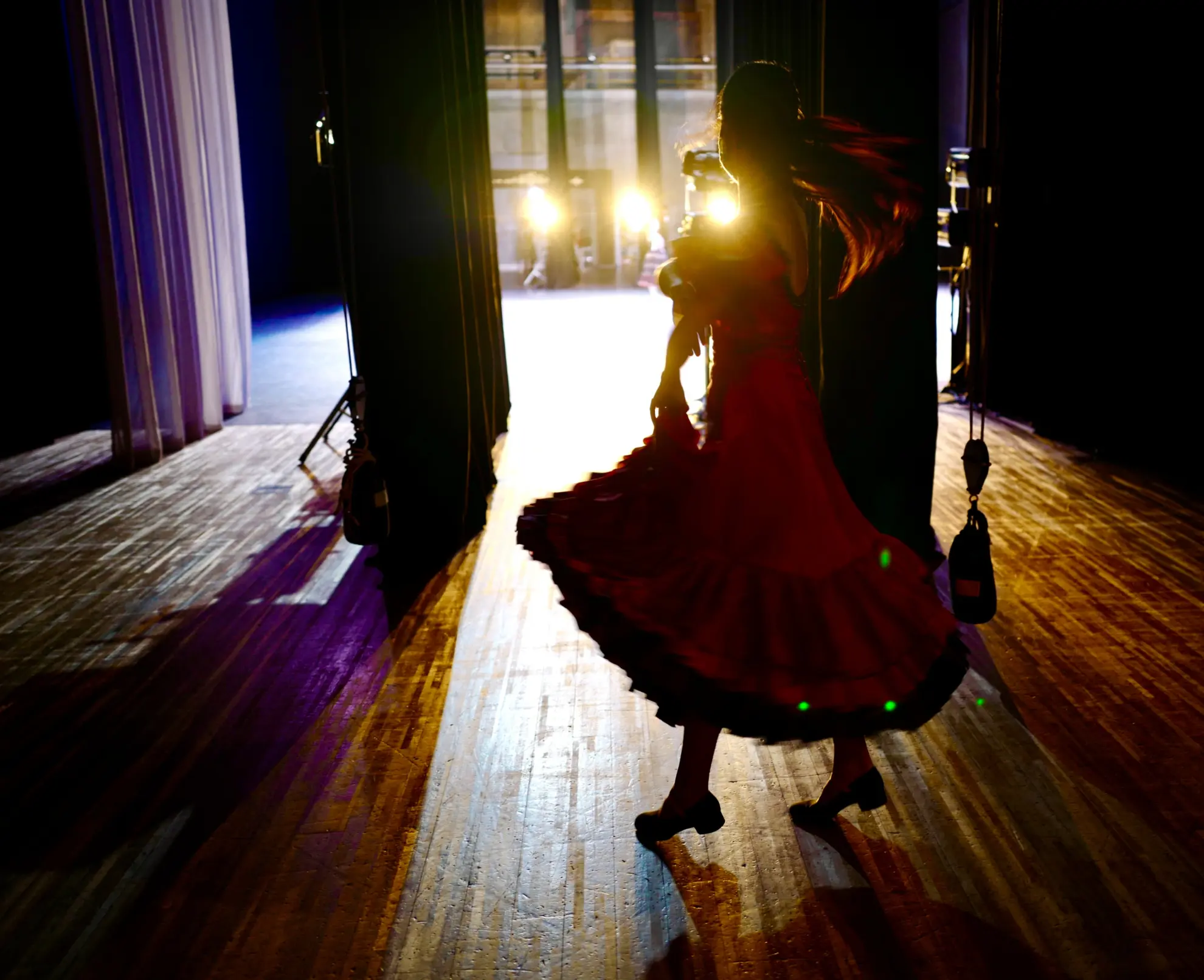 young girl looking out onto the stage