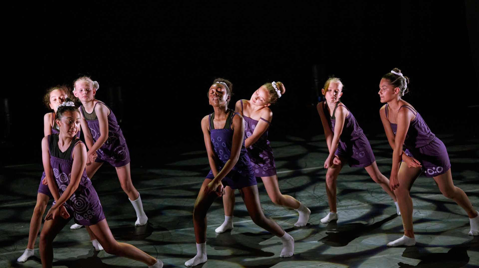young group of dancers performing lyrical on stage